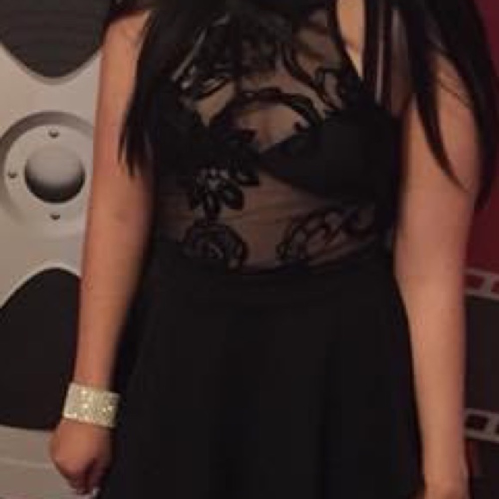 High on the sides of dress low on front and back black with see through